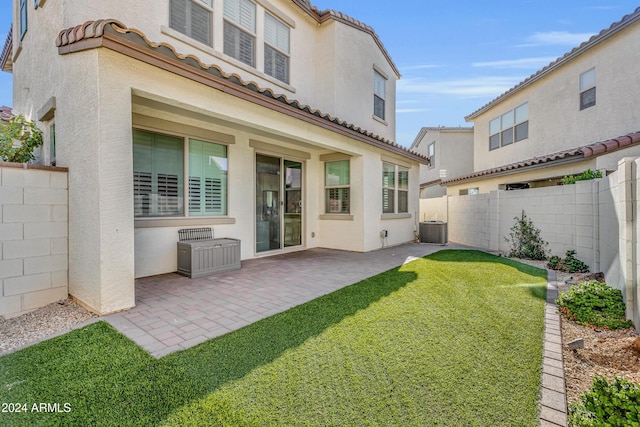 back of house featuring a yard, cooling unit, and a patio area