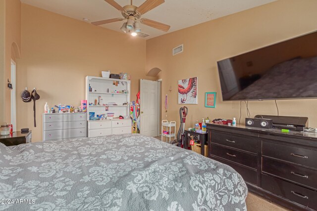 bedroom with ceiling fan and light carpet