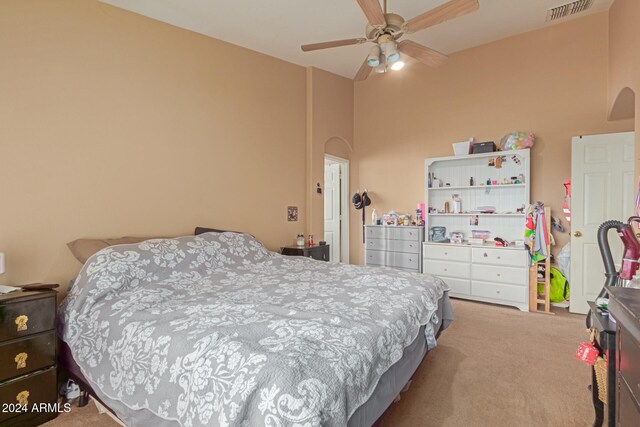 bedroom with ceiling fan and light carpet