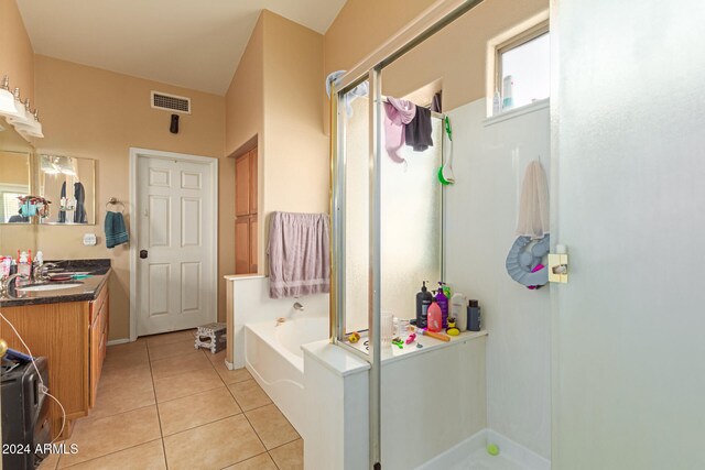 bathroom featuring tile patterned floors, vanity, and independent shower and bath