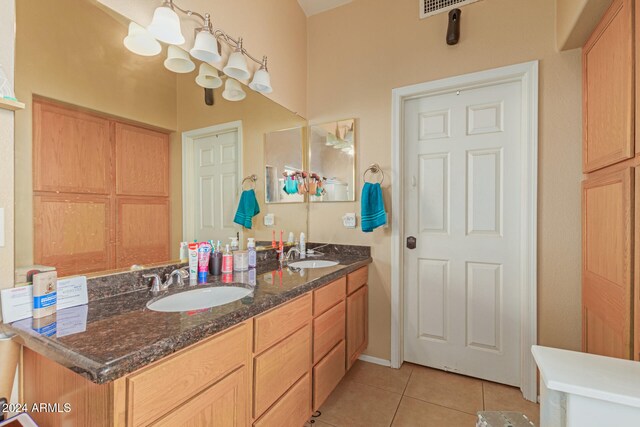 bathroom featuring tile patterned flooring and vanity