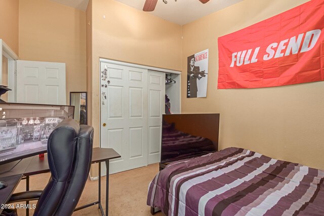 bedroom with light carpet, a closet, and ceiling fan