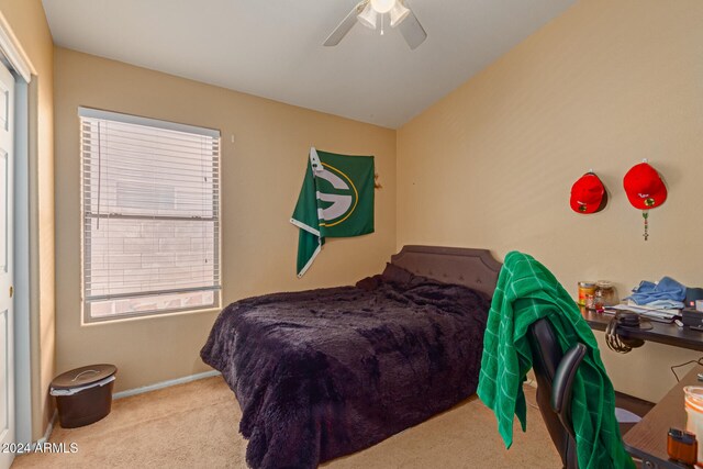 bedroom featuring ceiling fan, light colored carpet, and lofted ceiling