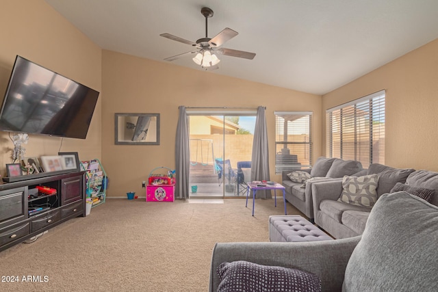 living room with carpet flooring, ceiling fan, a wealth of natural light, and vaulted ceiling