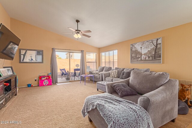 carpeted living room featuring ceiling fan and vaulted ceiling