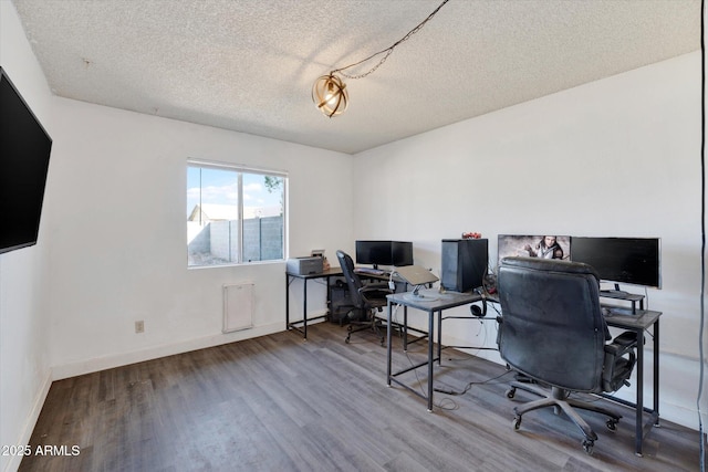 office with a textured ceiling, baseboards, and wood finished floors