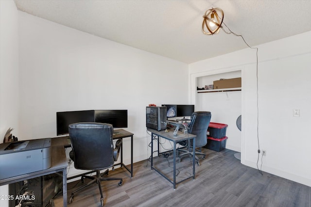 office area with wood finished floors and baseboards