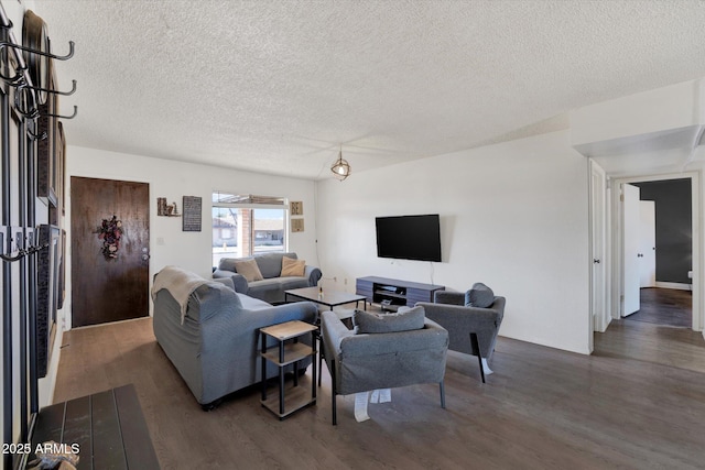 living room featuring a textured ceiling and wood finished floors