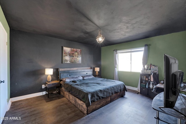 bedroom with baseboards and wood finished floors