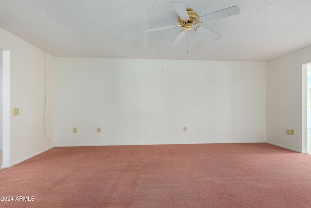 spare room with ceiling fan, light colored carpet, and a textured ceiling