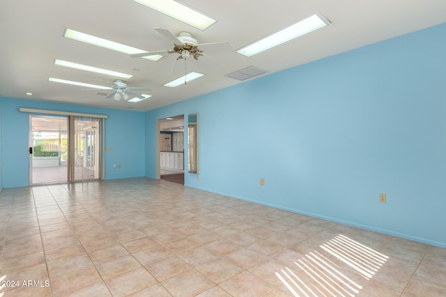 unfurnished room with ceiling fan and light tile patterned floors