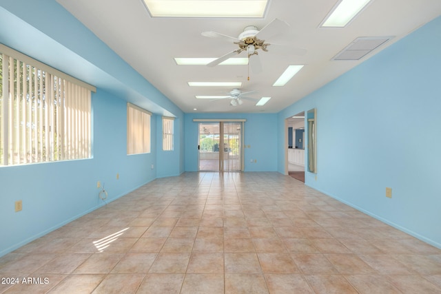 unfurnished room featuring ceiling fan, light tile patterned floors, and french doors