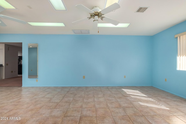 tiled empty room with ceiling fan