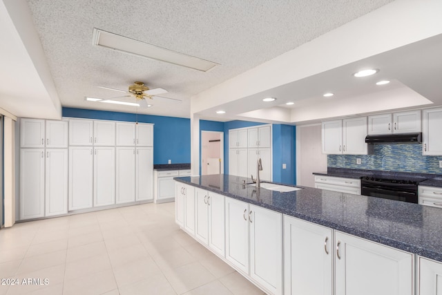 kitchen with electric range, sink, and white cabinets