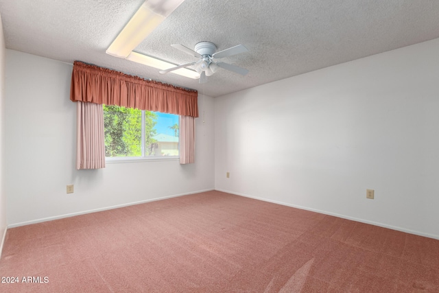 carpeted spare room with ceiling fan and a textured ceiling