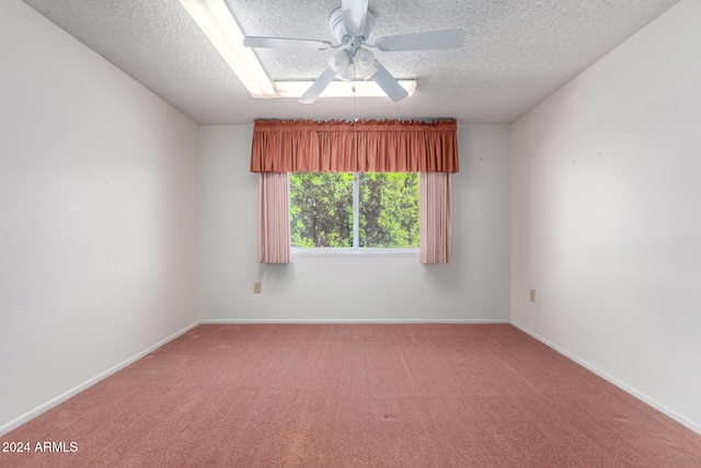 unfurnished room with ceiling fan, carpet, and a textured ceiling