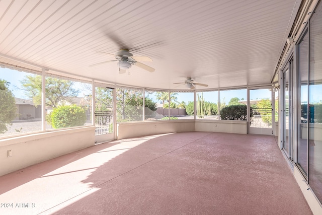 unfurnished sunroom featuring ceiling fan