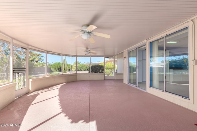 unfurnished sunroom with ceiling fan