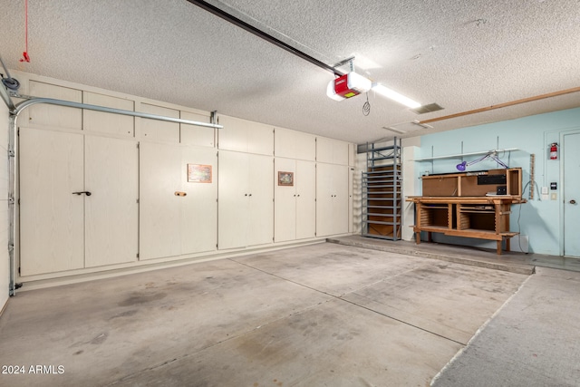 garage with a workshop area and a garage door opener