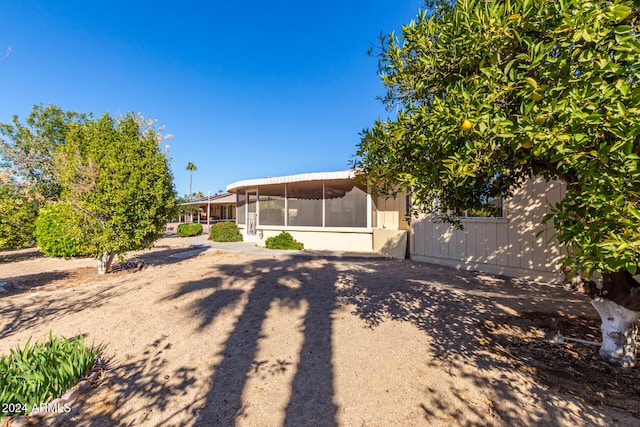 back of property with a sunroom