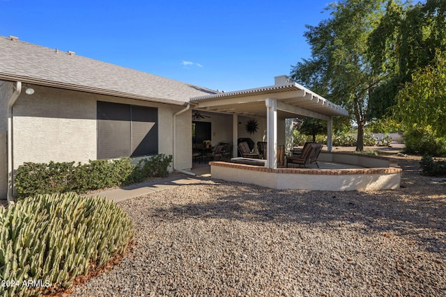 rear view of property with a patio, stucco siding, and ceiling fan