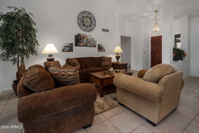 living area with visible vents, baseboards, and light tile patterned flooring