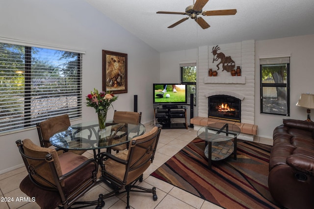 living area with light tile patterned floors, a ceiling fan, and lofted ceiling