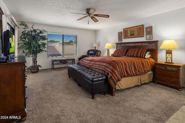 carpeted bedroom with ceiling fan and a textured ceiling