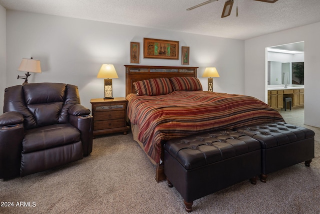 carpeted bedroom with ensuite bathroom, a textured ceiling, and ceiling fan