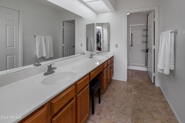 bathroom featuring vanity, a shower with shower door, and tile patterned floors