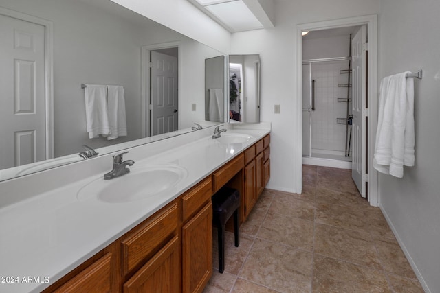full bathroom with a shower stall, double vanity, and a sink