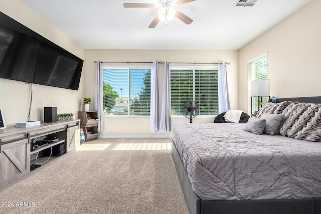bedroom with light colored carpet, baseboards, and ceiling fan