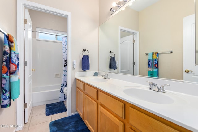 full bathroom featuring double vanity, tile patterned floors, shower / tub combo with curtain, and toilet
