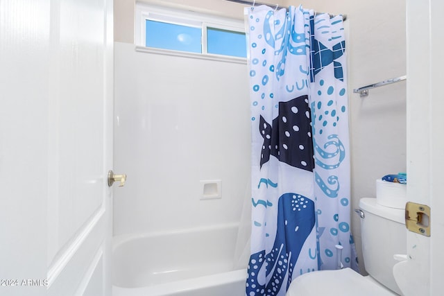 full bath featuring toilet and shower / bath combo with shower curtain