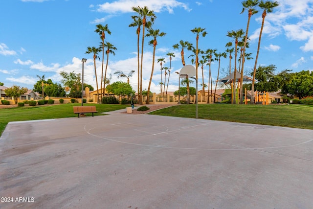 surrounding community with a yard and community basketball court
