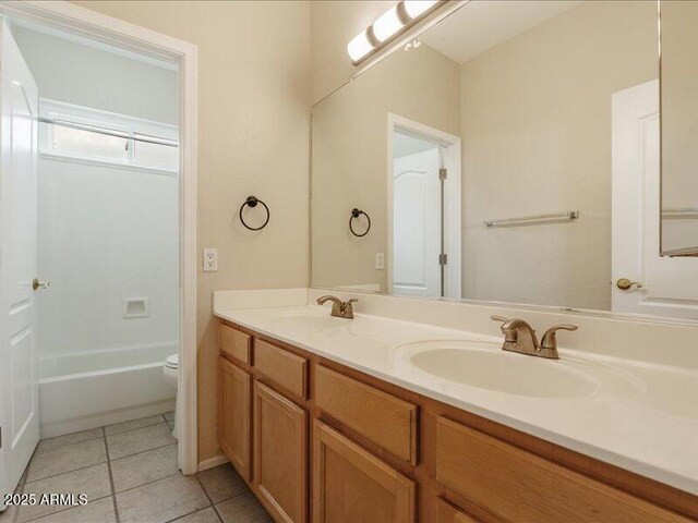 full bathroom featuring tile patterned floors, double vanity, and toilet