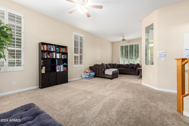 living room with a ceiling fan, carpet flooring, and baseboards