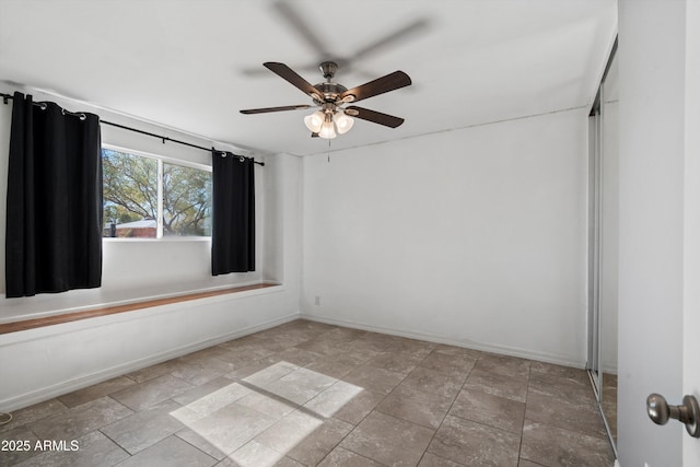 spare room with ceiling fan