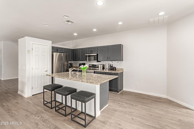 kitchen featuring baseboards, stainless steel appliances, and visible vents