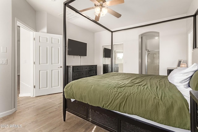 bedroom with arched walkways, baseboards, ceiling fan, and light wood-style flooring