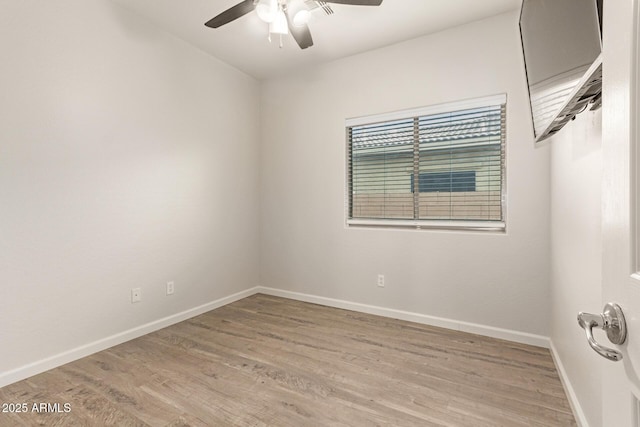 unfurnished room featuring baseboards, a ceiling fan, and light wood finished floors