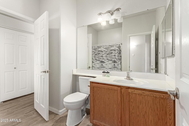 full bathroom featuring vanity, toilet, wood finished floors, and a shower with shower curtain