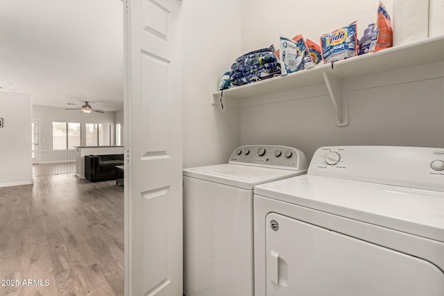 clothes washing area with laundry area, light wood-style flooring, independent washer and dryer, and ceiling fan