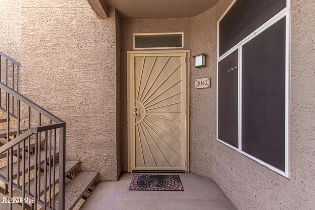 view of exterior entry with stucco siding