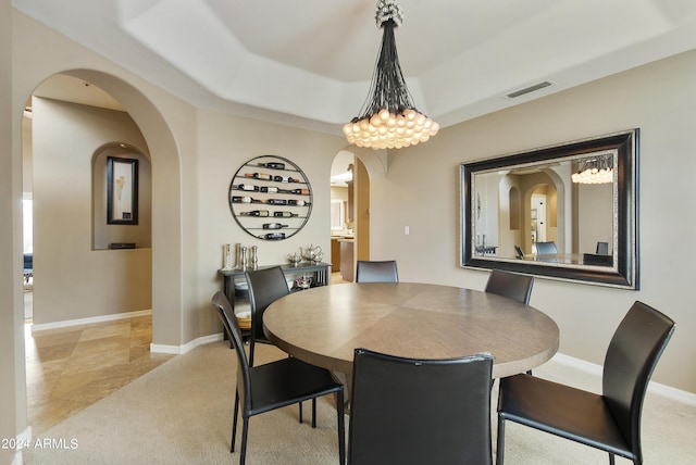 dining area with light tile patterned floors and a notable chandelier