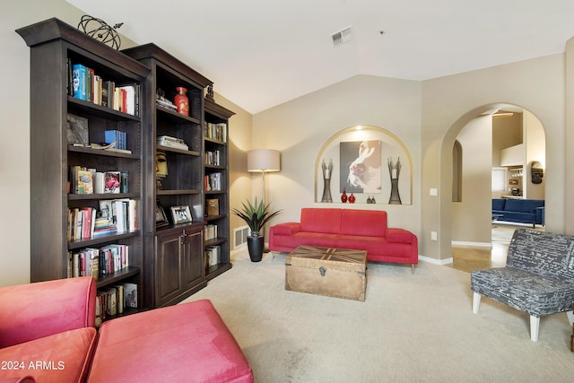 living room with carpet floors and vaulted ceiling