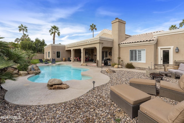 view of pool featuring a fire pit and a patio area