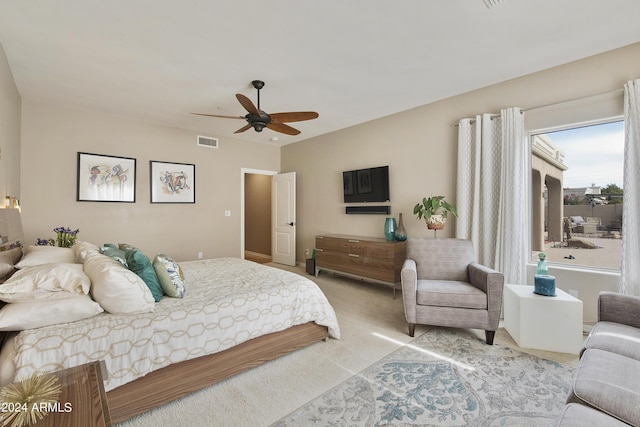 bedroom with ceiling fan and light carpet