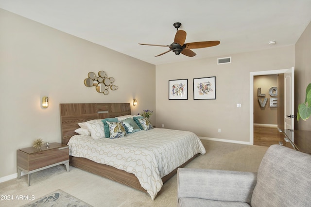 bedroom featuring light colored carpet and ceiling fan