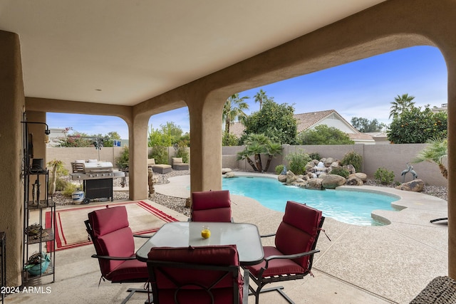 view of swimming pool with a patio and grilling area